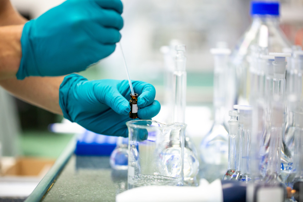 Scientist With Test Tube In Lab