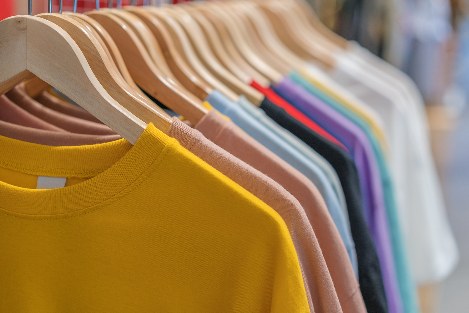 Different Tshirts Hanging In A Retail Store