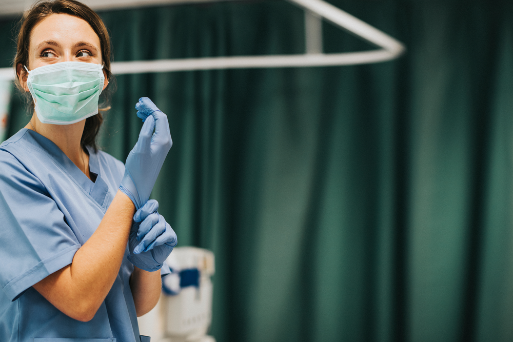 Nurse Wearing A Mask And Gloves In Hospital